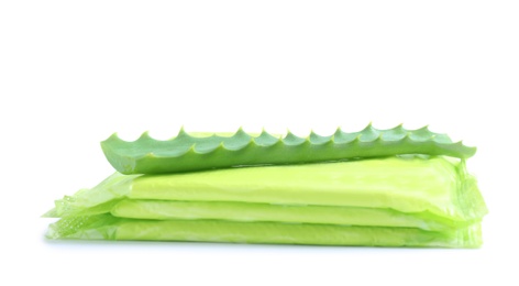 Stack of menstrual pads and aloe leaf on white background. Gynecological care