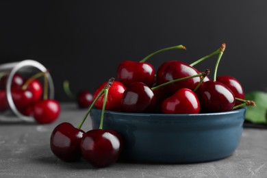 Photo of Fresh ripe cherries on grey table, closeup