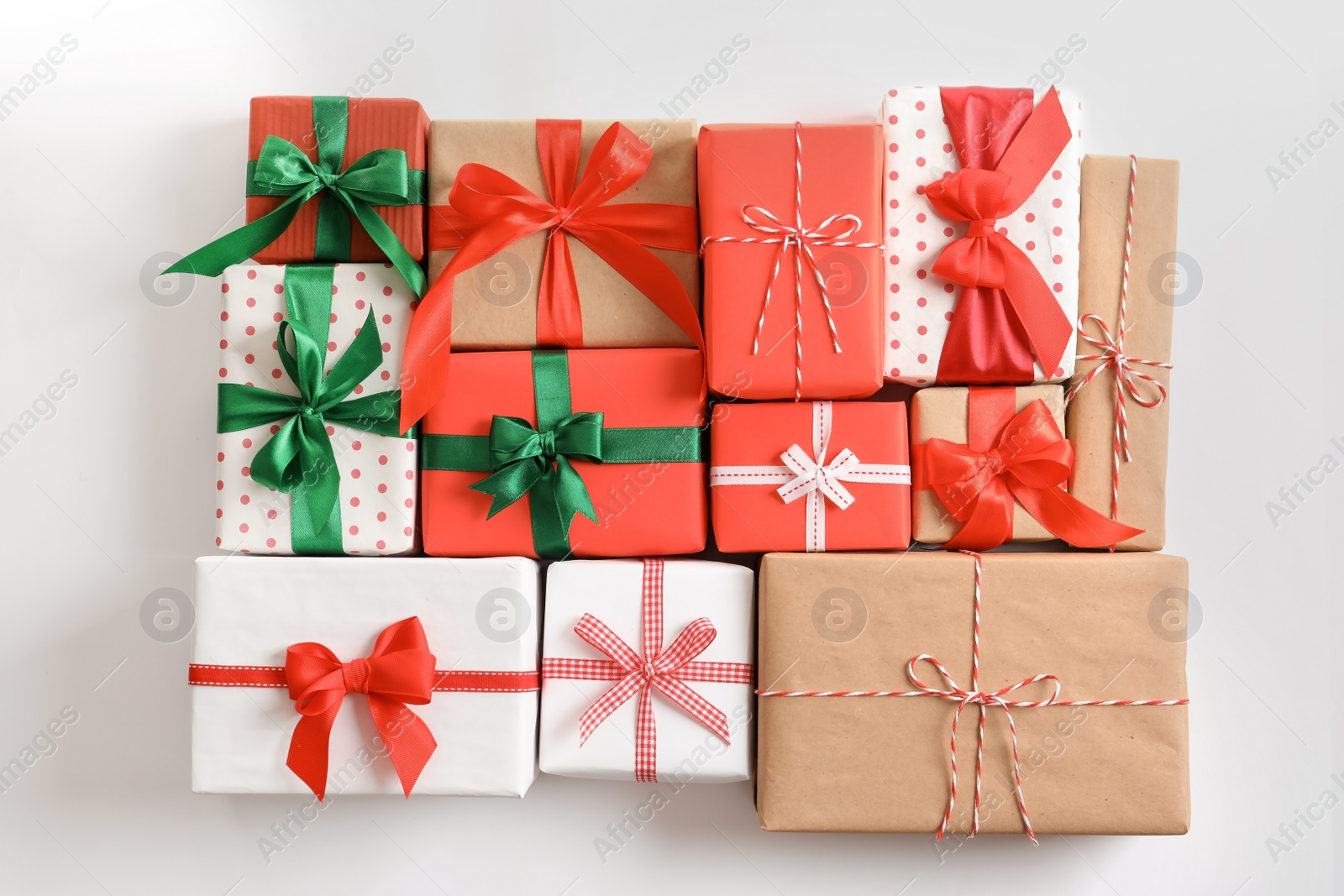 Photo of Beautifully wrapped gift boxes on white background