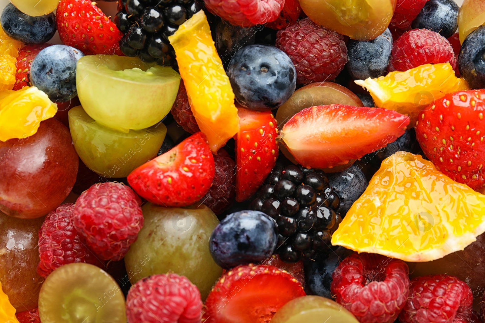 Photo of Fresh tasty fruit salad as background, top view