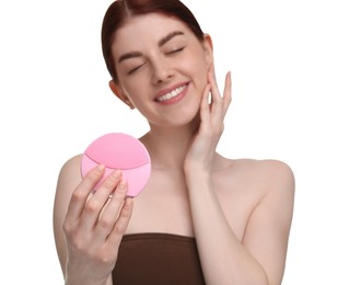 Photo of Washing face. Young woman with cleansing brush on white background, selective focus