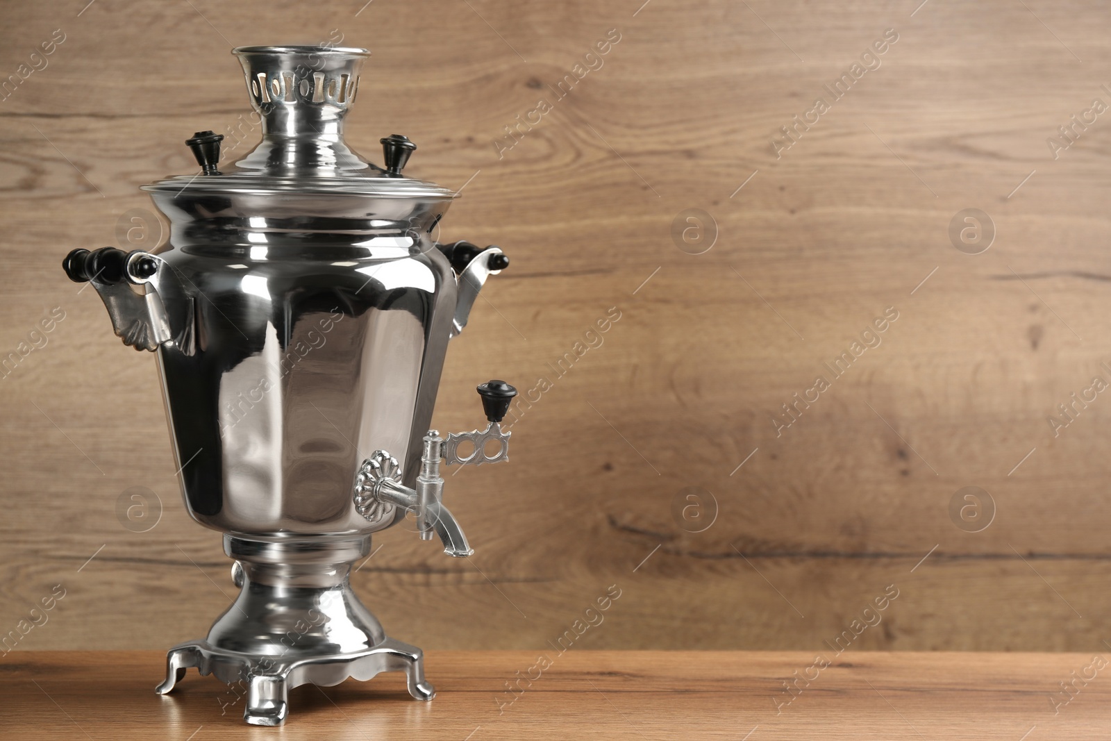Photo of Traditional Russian samovar on wooden background. Space for text