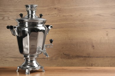 Traditional Russian samovar on wooden background. Space for text