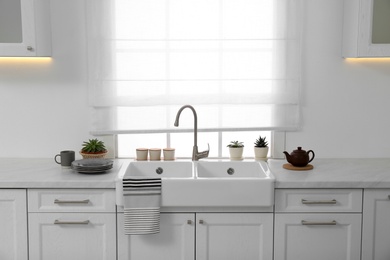 Photo of Beautiful view of light modern kitchen. Interior design