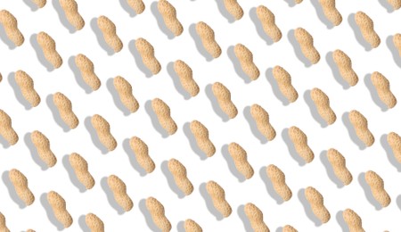 Image of Unpeeled peanuts on white background. Pattern, banner design