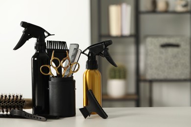 Photo of Set of hairdresser tools on table in salon, space for text