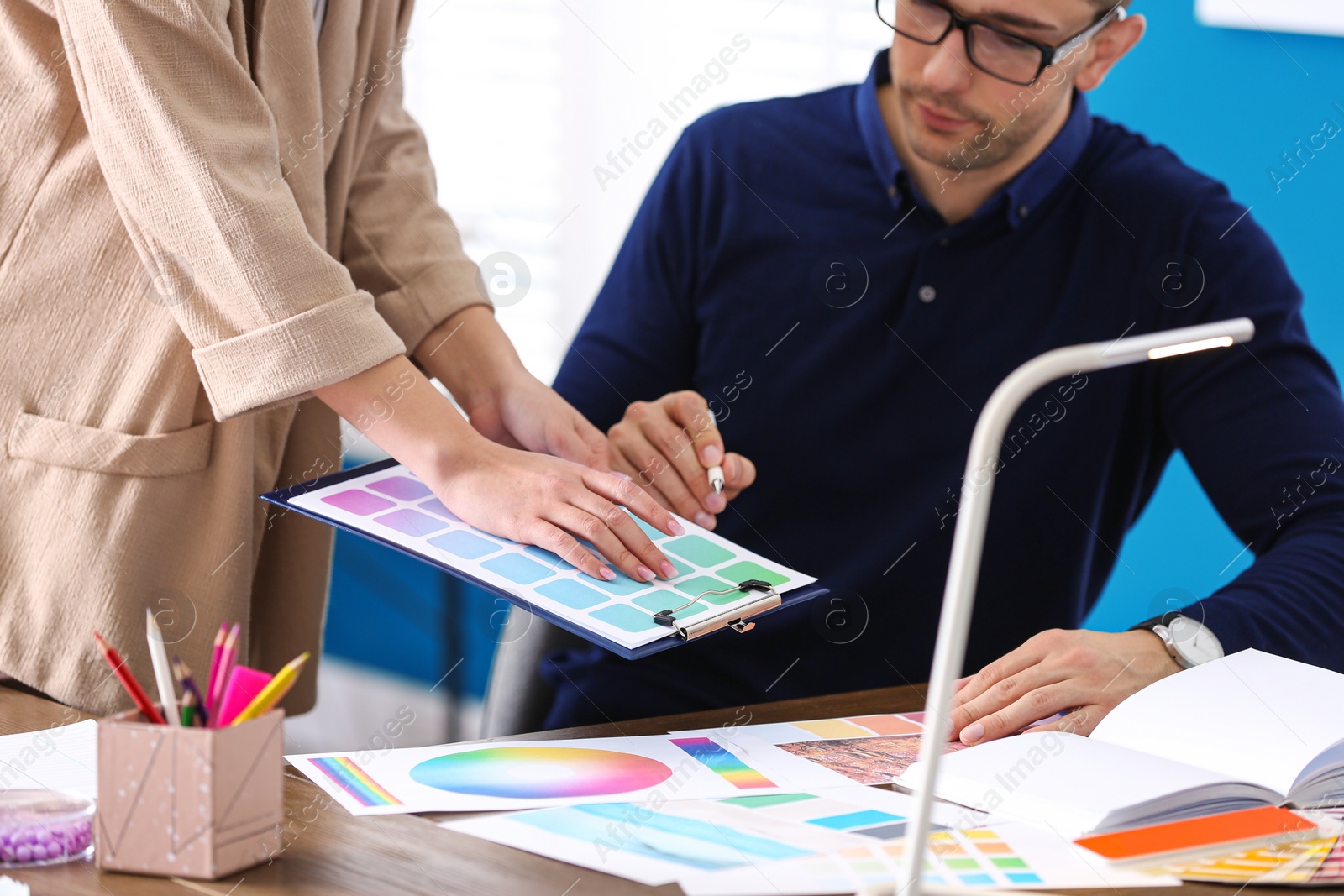 Photo of Professional interior designer with colleague working in office, closeup