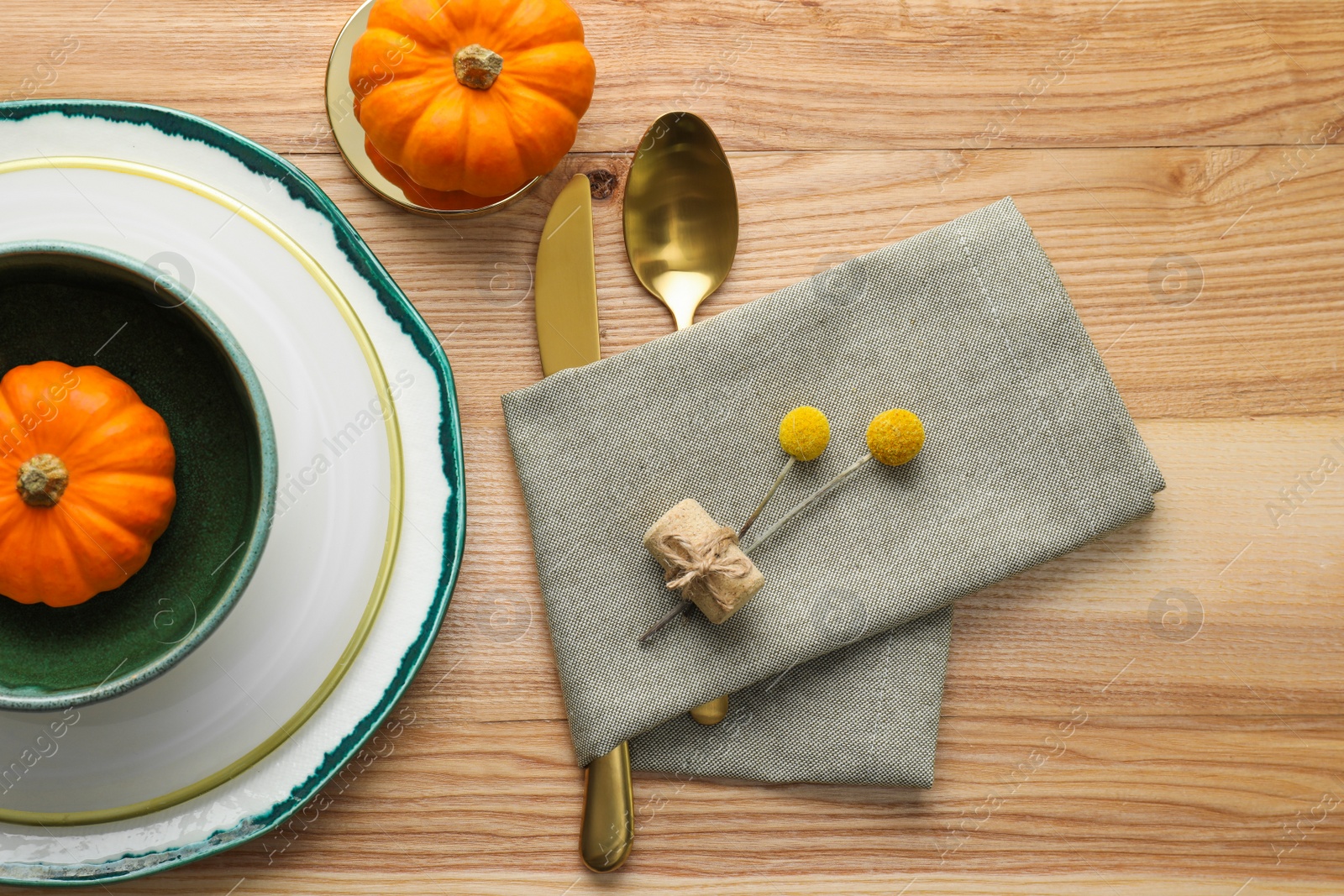 Photo of Autumn table setting with pumpkins on wooden background, flat lay