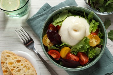 Photo of Delicious burrata salad with colorful cherry tomatoes and arugula served on white wooden table, flat lay