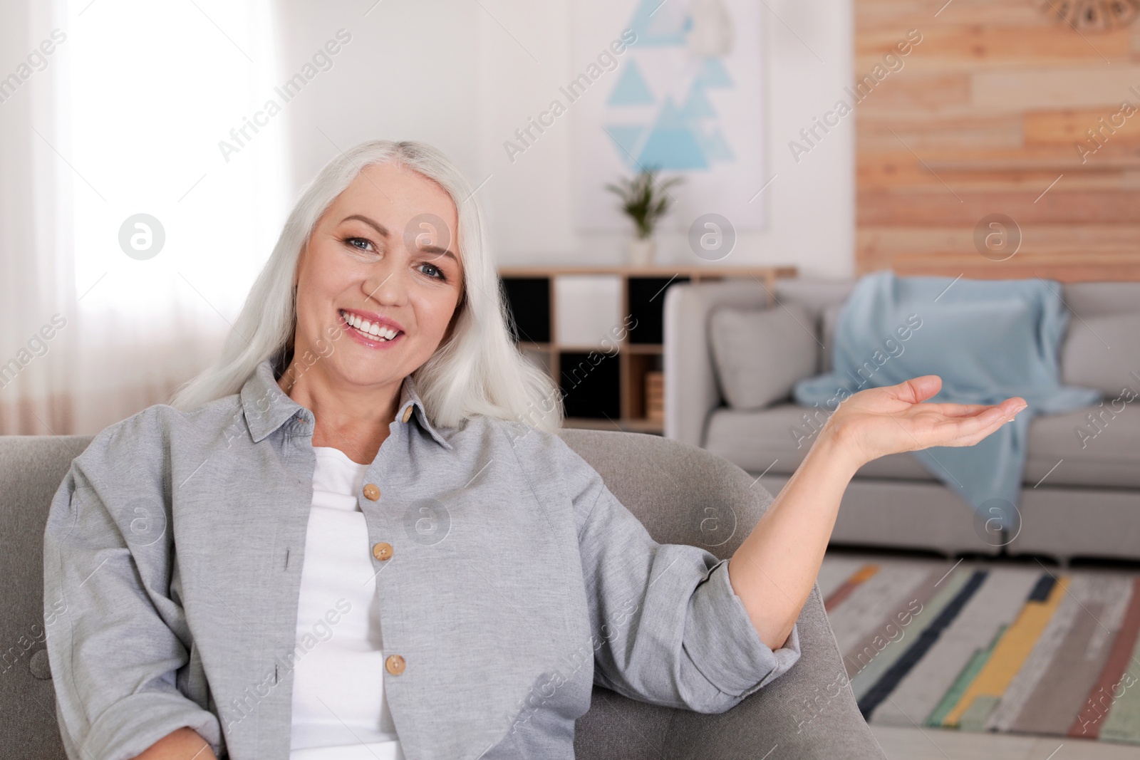 Photo of Portrait of mature woman in living room