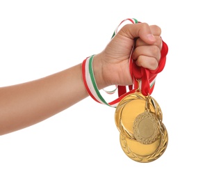 Photo of Woman holding gold medals on white background, closeup
