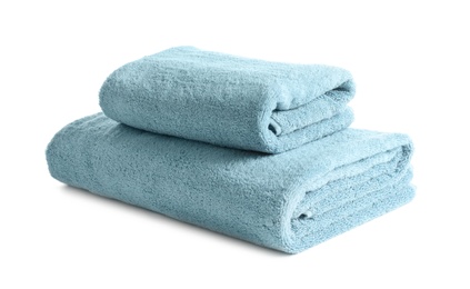 Folded clean soft towels on white background