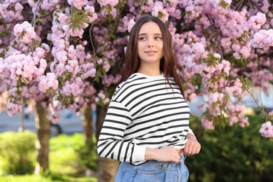 Photo of Beautiful woman near blossoming tree on spring day