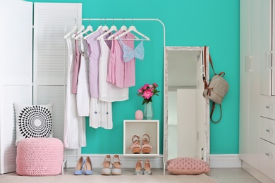 Photo of Stylish dressing room interior with clothes rack and mirror