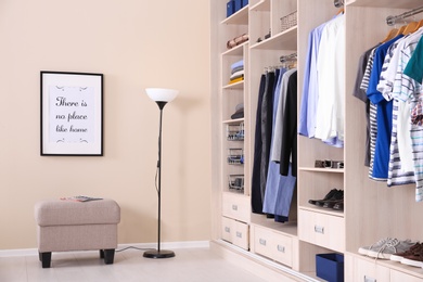 Photo of Room interior with wardrobe and stylish ottoman chair