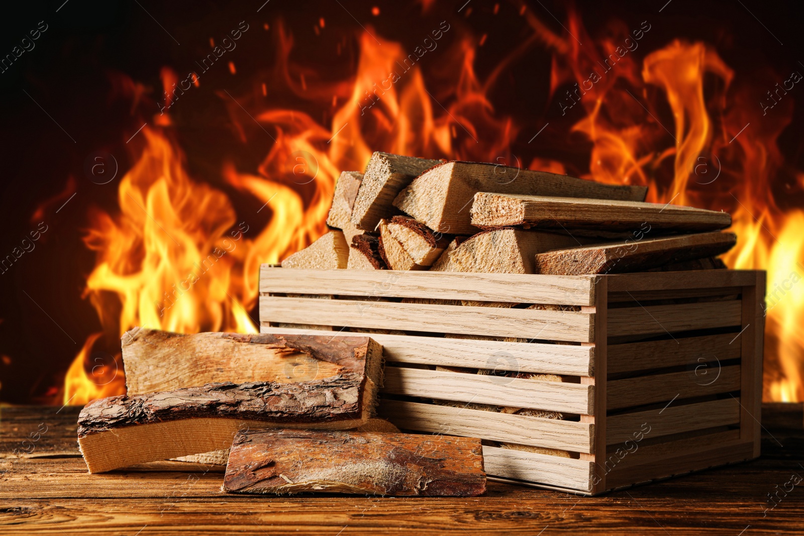 Image of Dry wood and burning fire on background. Cozy atmosphere