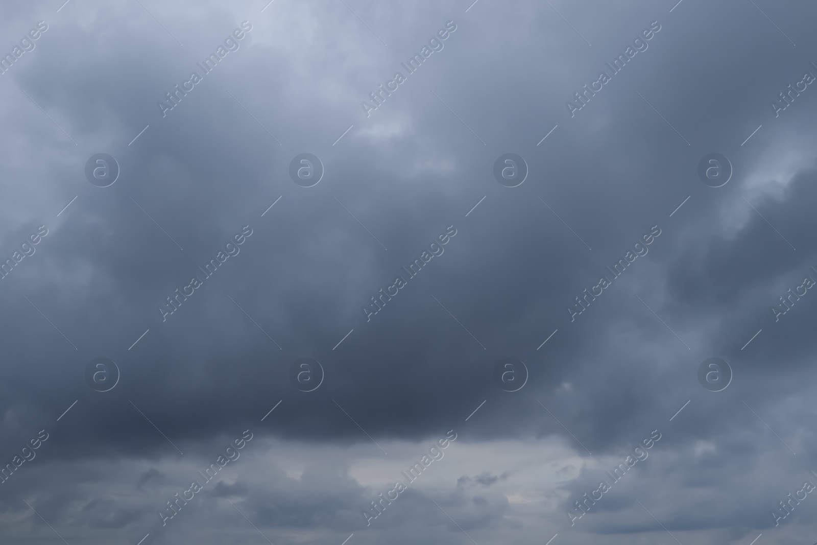 Photo of Sky with heavy rainy clouds on grey day