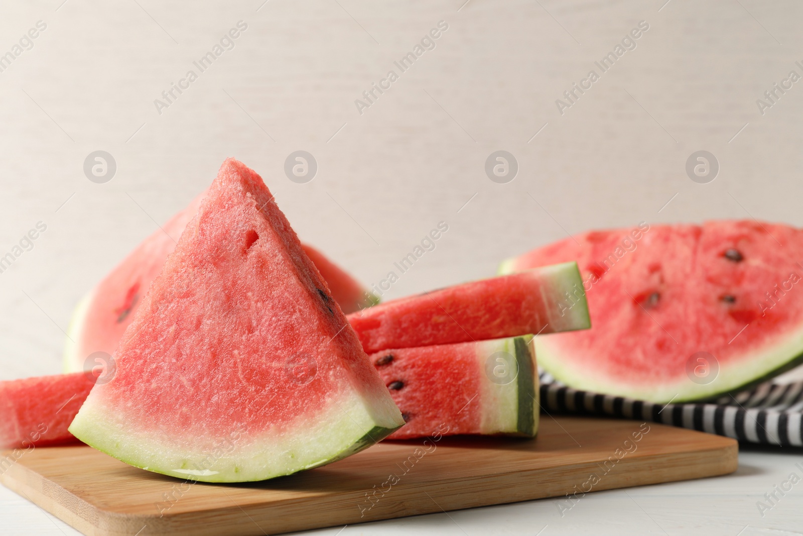 Photo of Delicious fresh watermelon slices on white table