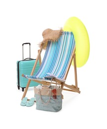 Photo of Deck chair, inflatable ring, suitcase and beach accessories isolated on white