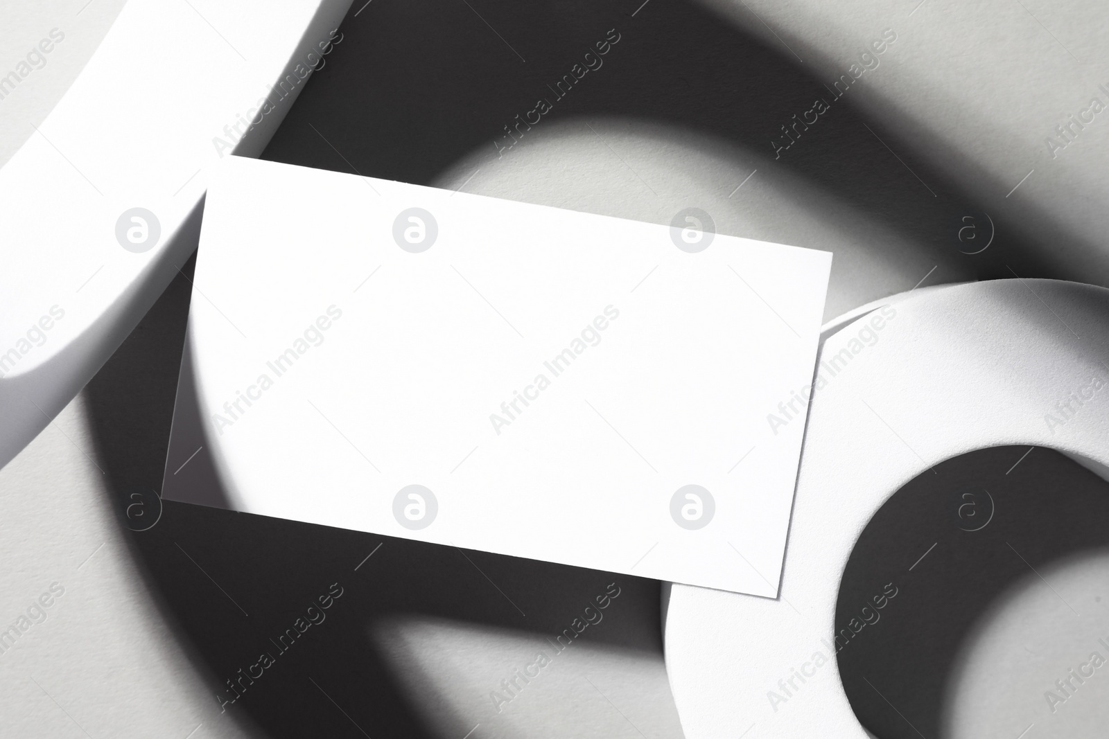 Photo of Empty business card and decorative elements on white background, top view. Mockup for design
