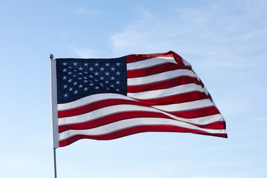 Photo of American flag fluttering outdoors on sunny day