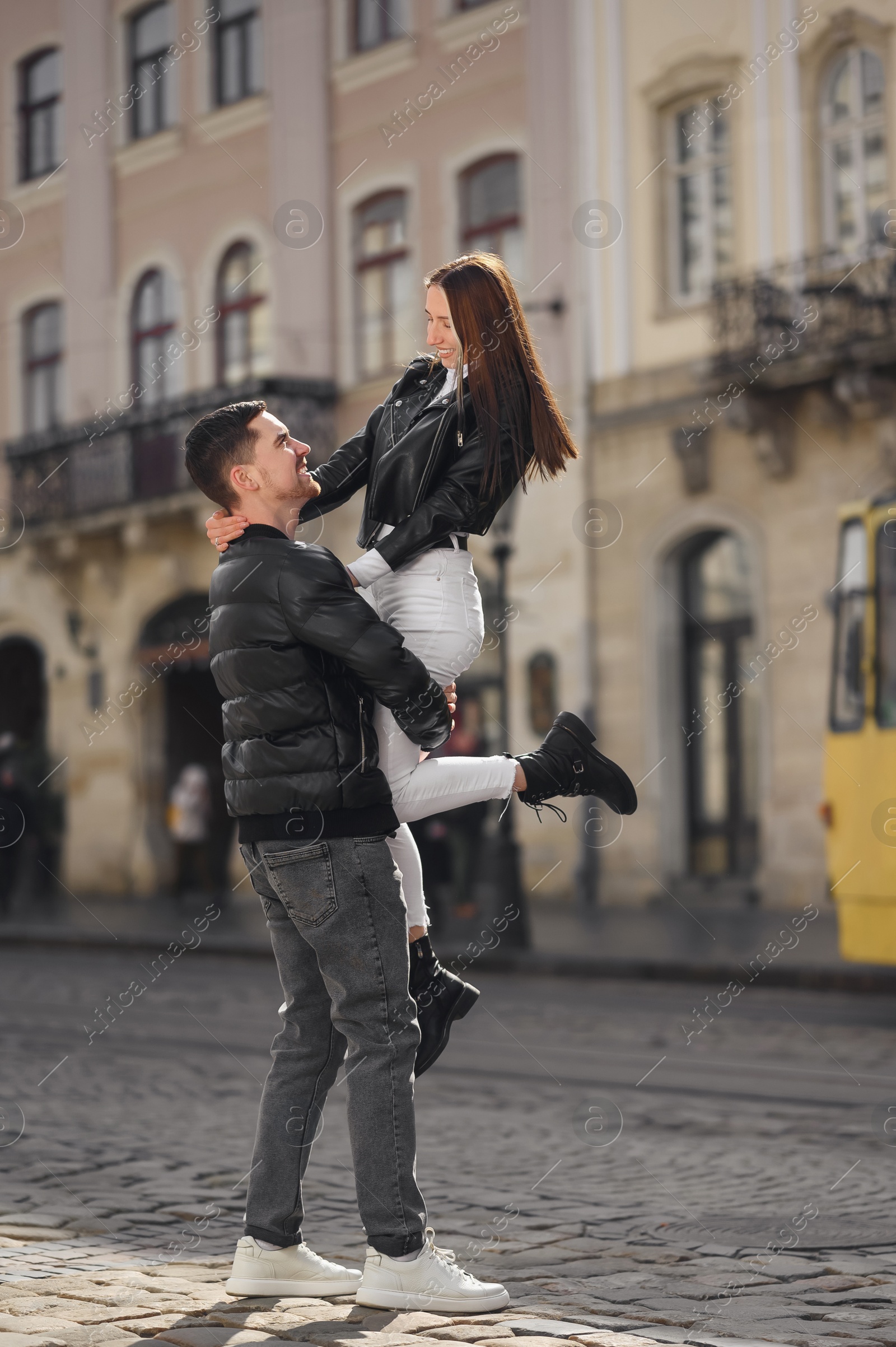 Photo of Lovely young couple having fun together on city street. Romantic date