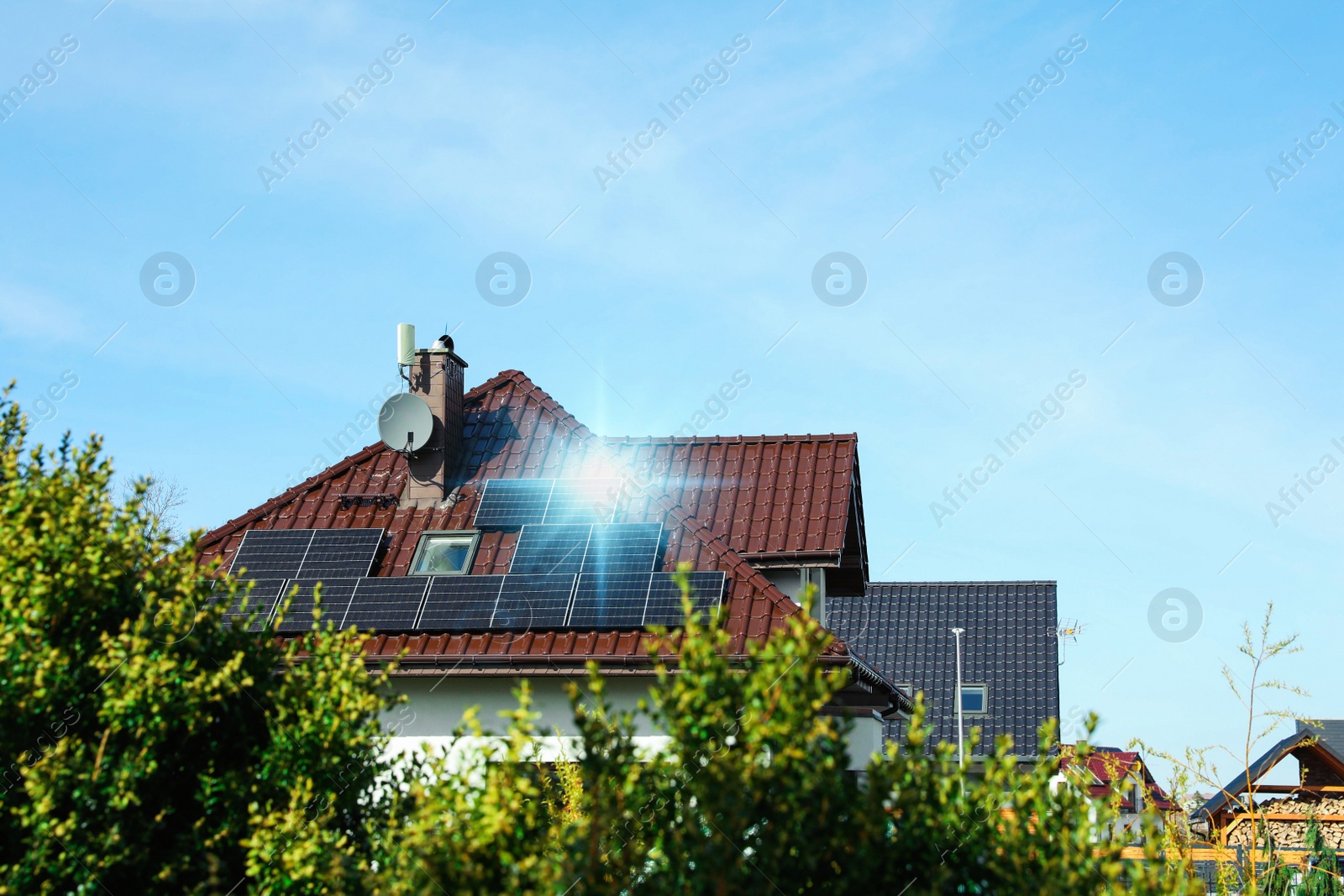 Photo of House with installed solar panels on roof, space for text. Alternative energy