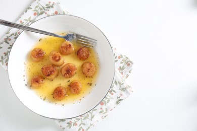 Photo of Delicious fried scallops served on white table, top view. Space for text