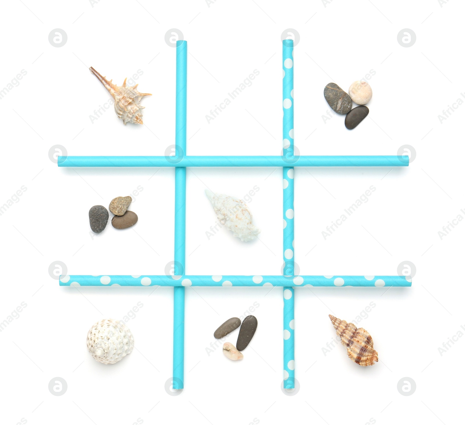 Photo of Tic tac toe game made with sea treasures isolated on white, top view