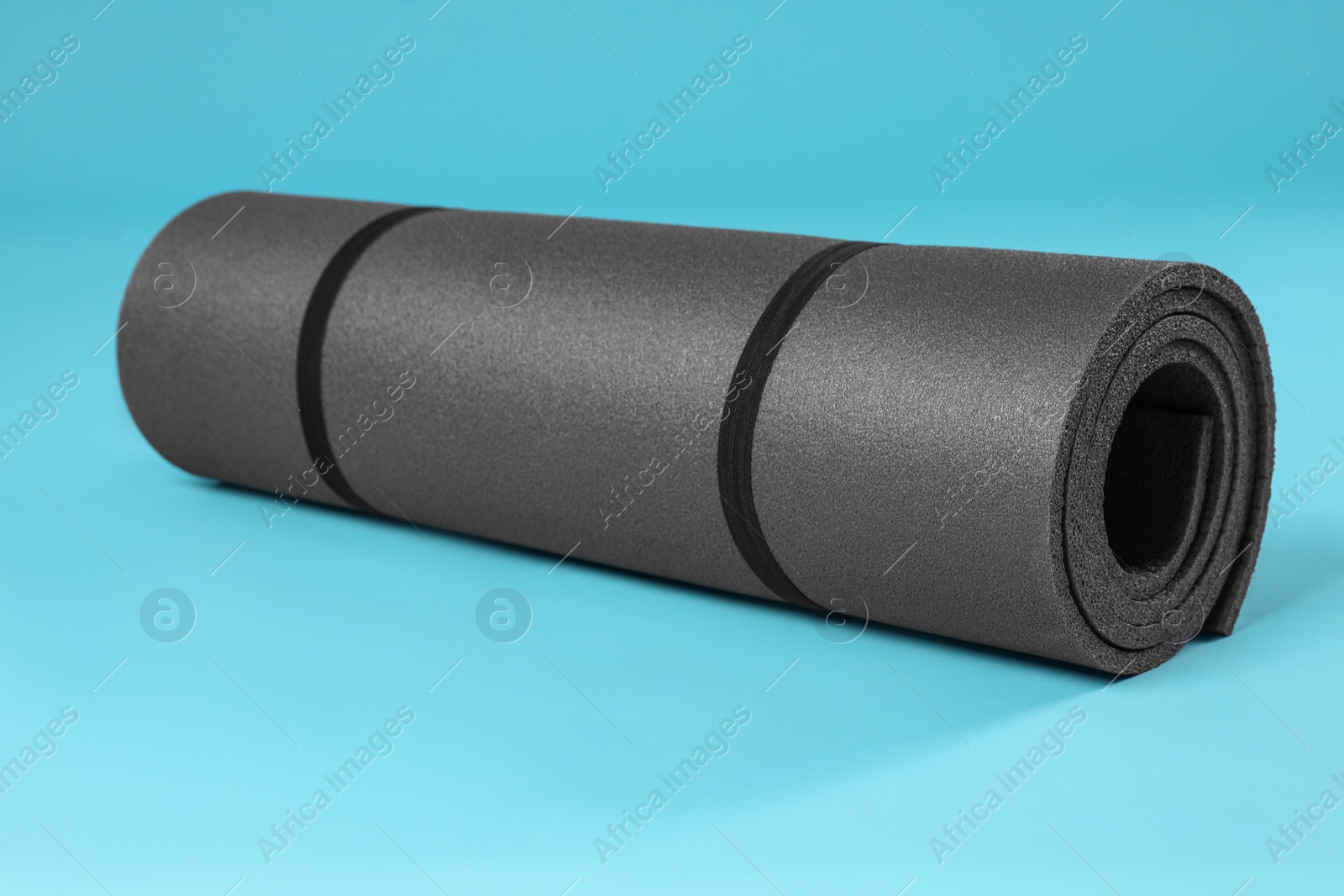 Photo of Grey yoga mat on light blue background