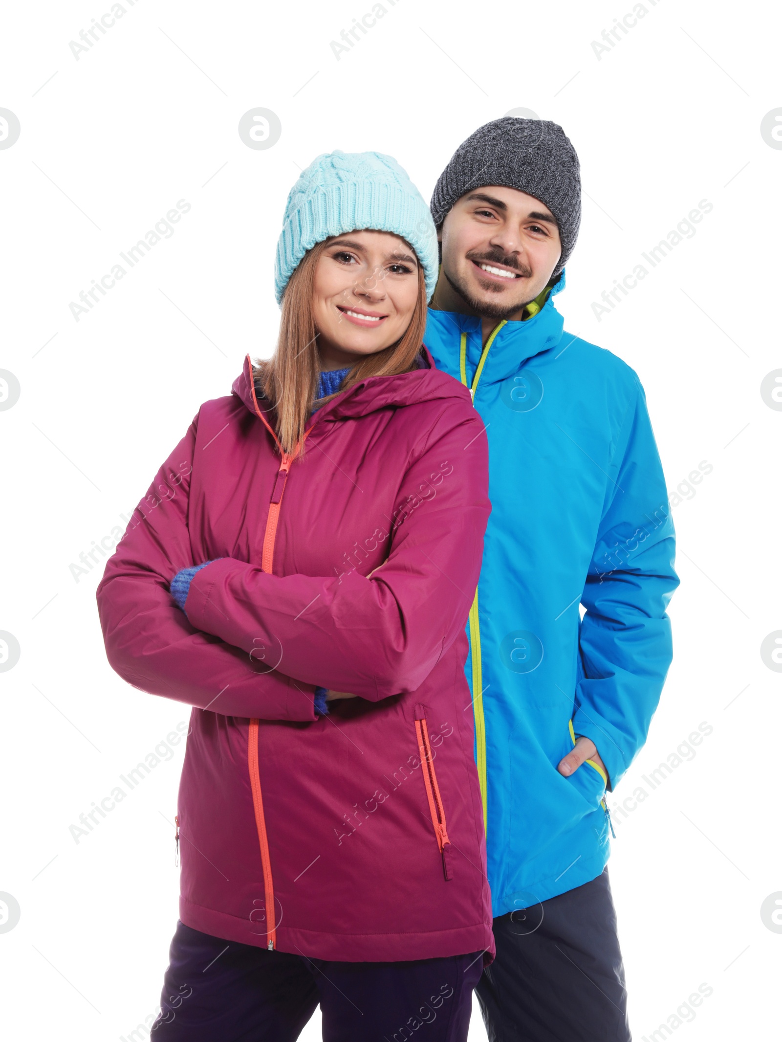 Photo of Young couple wearing warm clothes on white background. Ready for winter vacation