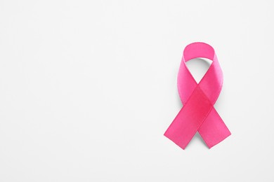 Pink ribbon on white background, top view and space for text. Breast cancer awareness