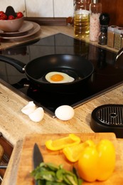 Photo of Frying eggs for breakfast in kitchen, selective focus
