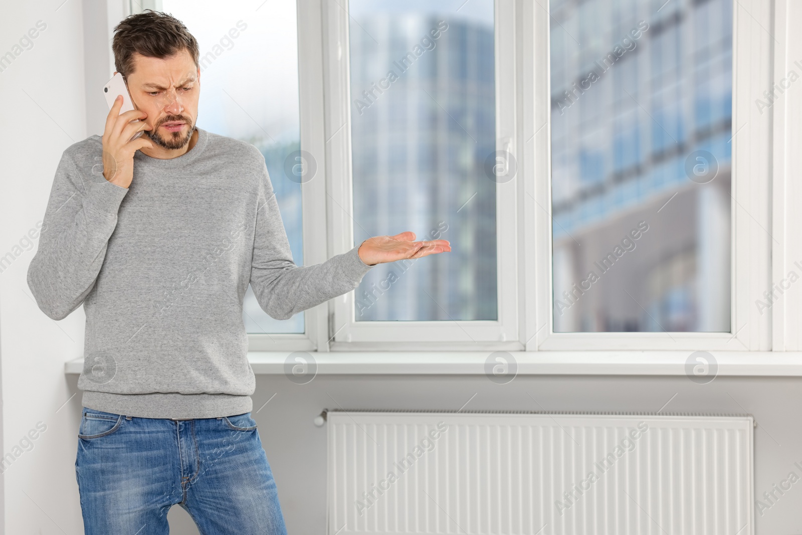 Photo of Man talking on phone near window indoors, space for text