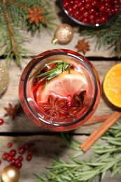 Aromatic punch drink and Christmas decor on wooden table, top view