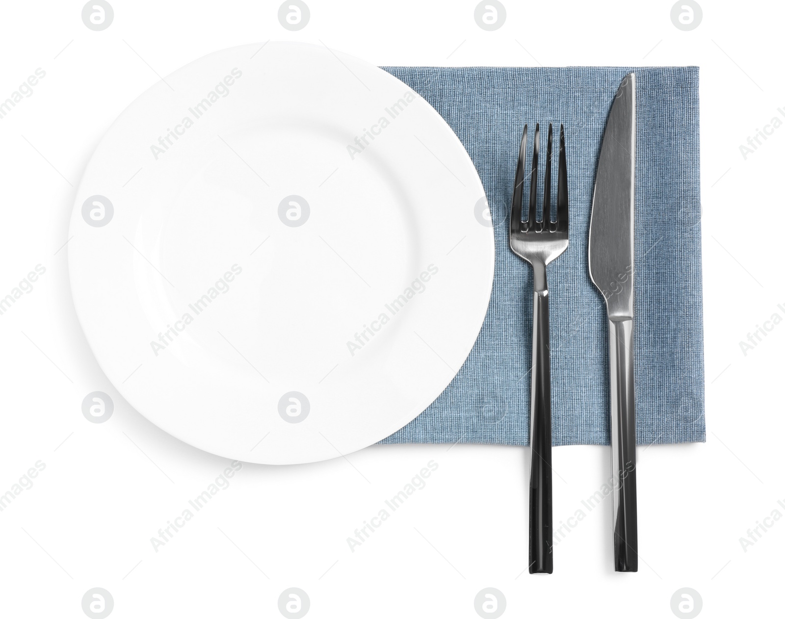 Photo of Clean plate and shiny cutlery on white background, top view