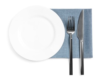 Clean plate and shiny cutlery on white background, top view