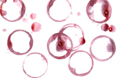 Red wine rings and drops on white background, top view