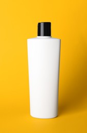 One bottle of shampoo on yellow background