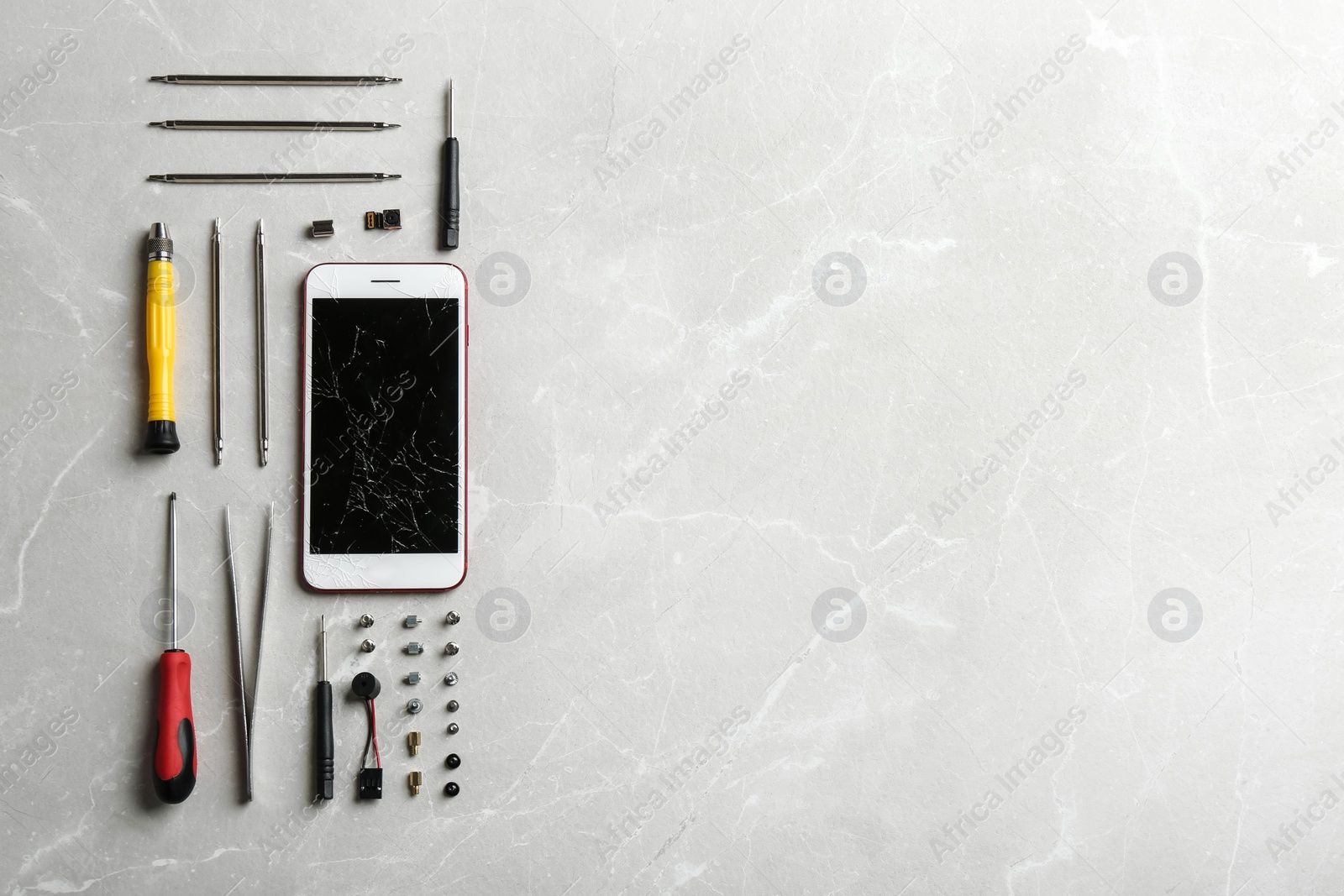 Photo of Broken mobile phone and repair tools on table, flat lay. Space for text