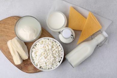 Different fresh dairy products on light table, flat lay