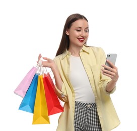 Photo of Stylish young woman with shopping bags and smartphone white background