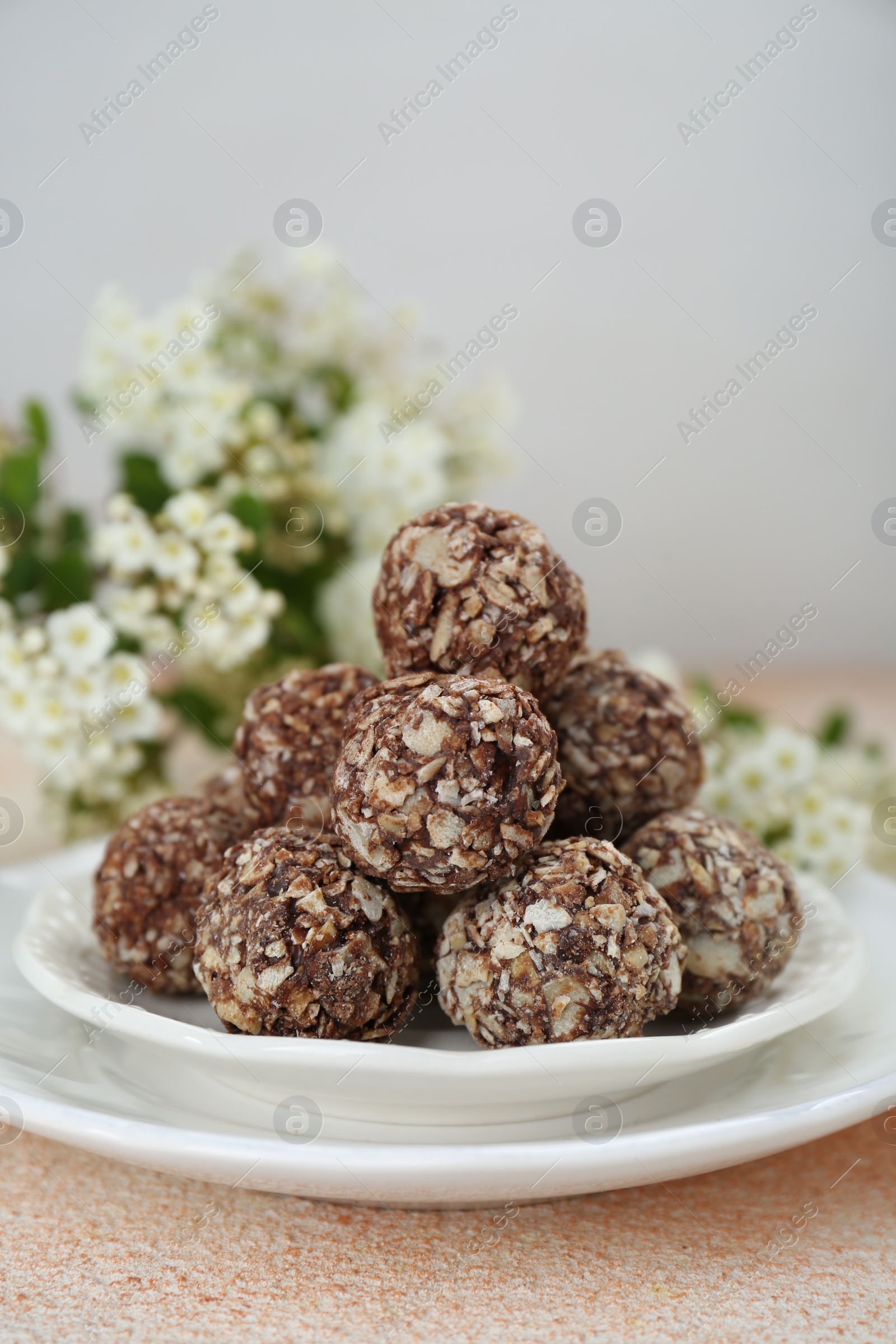 Photo of Delicious sweet chocolate candies on beige table