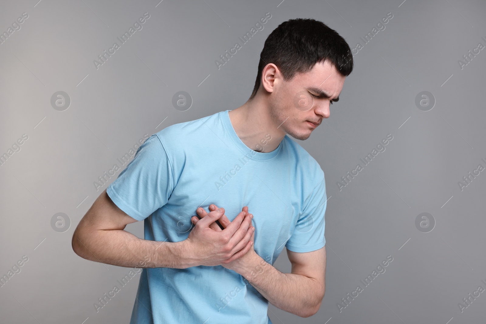 Photo of Man suffering from heart hurt on grey background