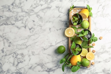 Flat lay composition with delicious mint julep cocktail on marble background