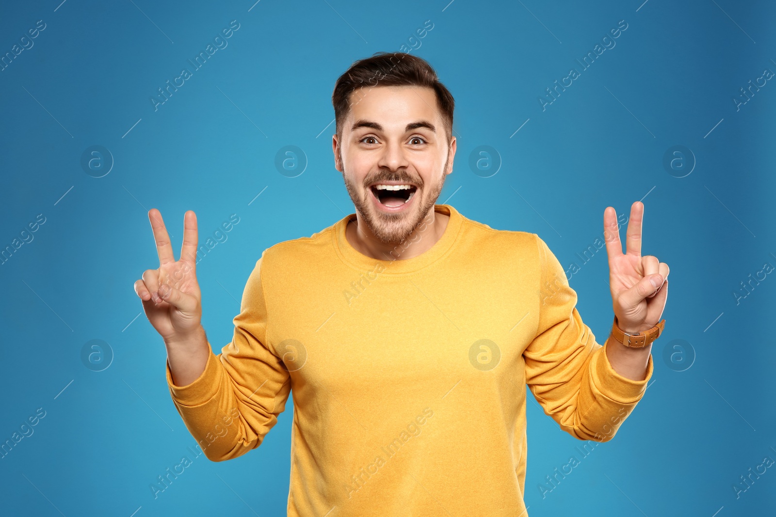 Photo of Portrait of handsome young man on color background