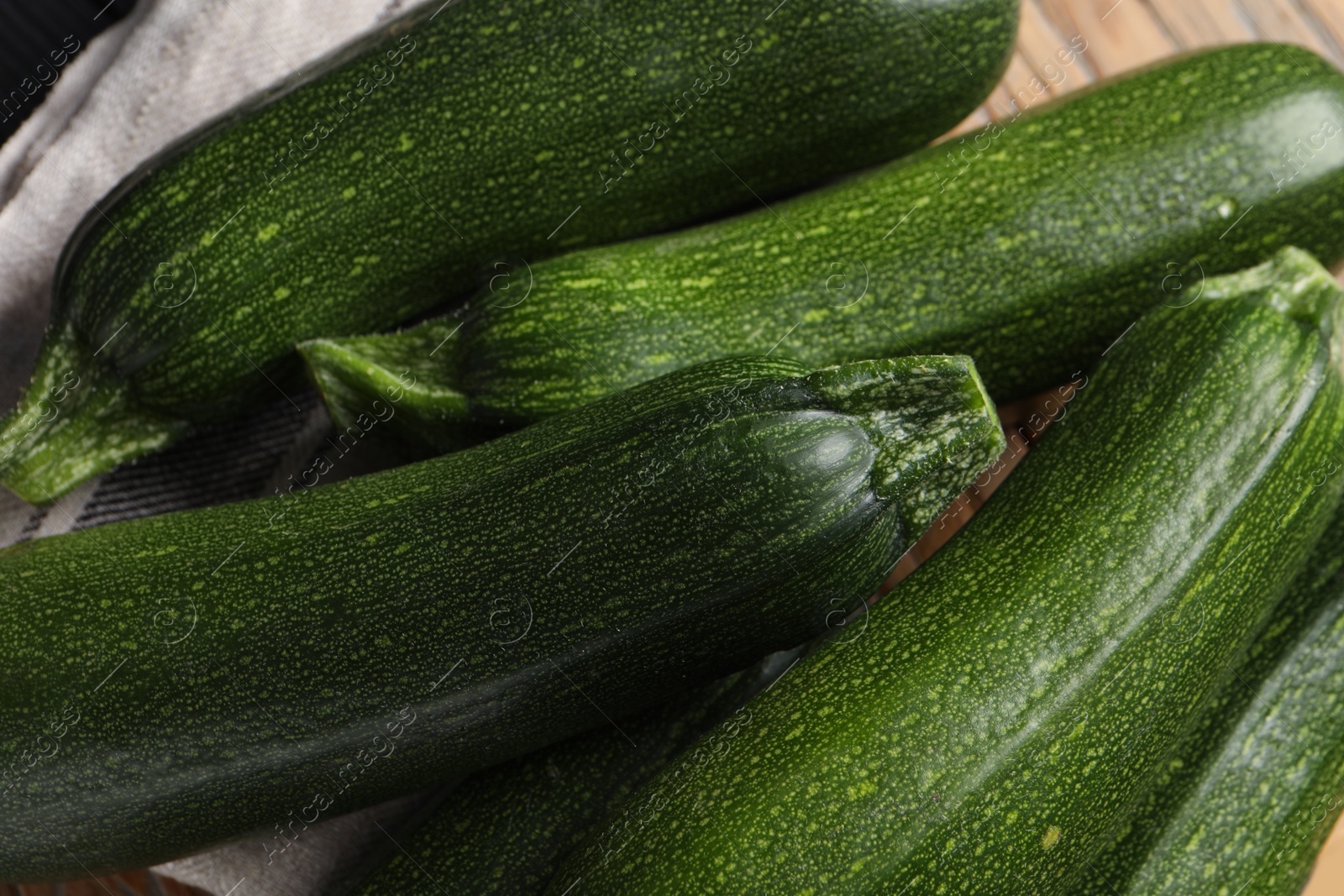 Photo of Many raw ripe zucchinis on table, closeup