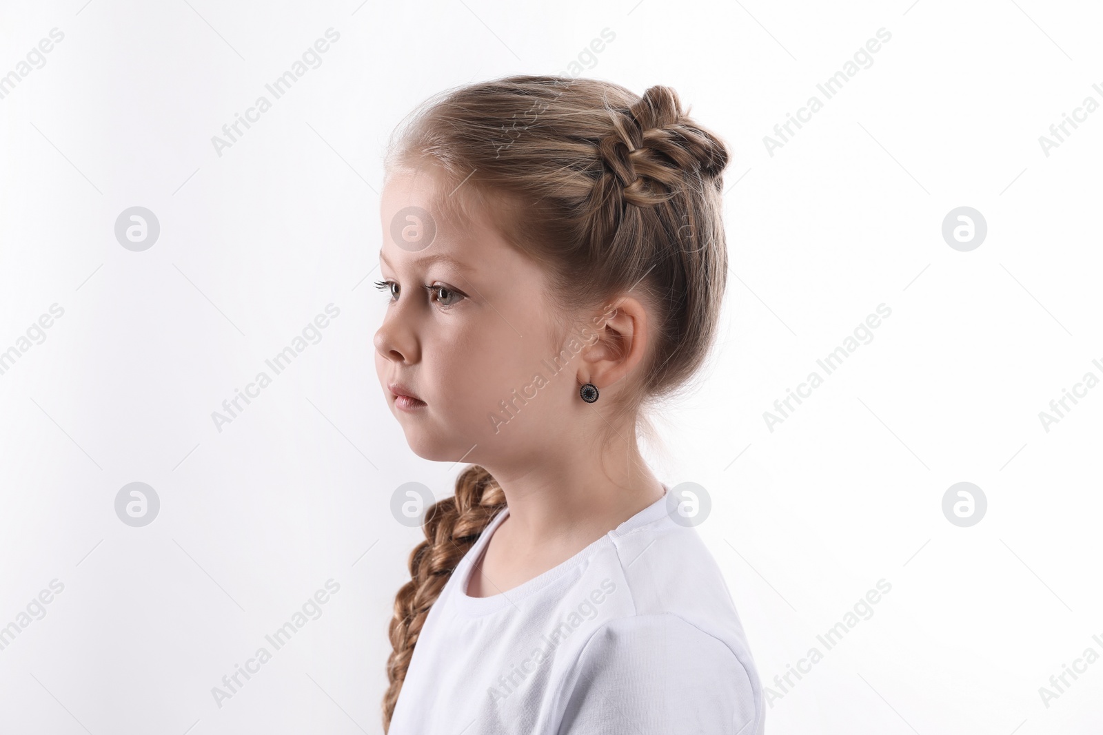 Photo of Little girl with braided hair on white background
