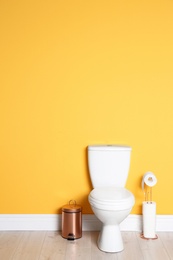 Photo of New ceramic toilet bowl in modern bathroom with space for text