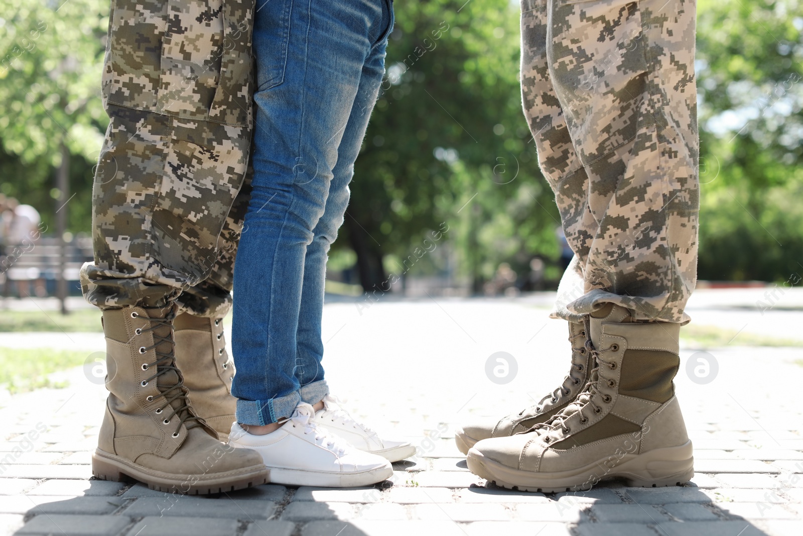 Photo of Military couple with their son walking in park